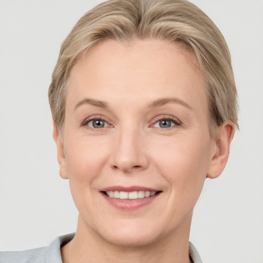 Joyful white adult female with short  brown hair and grey eyes