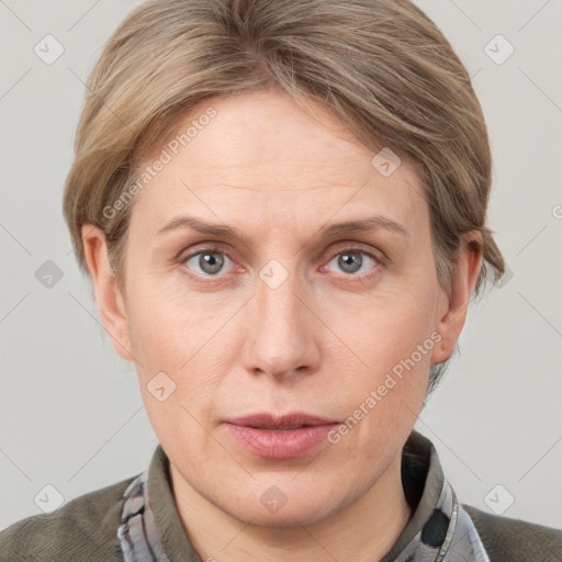 Joyful white adult female with short  brown hair and grey eyes