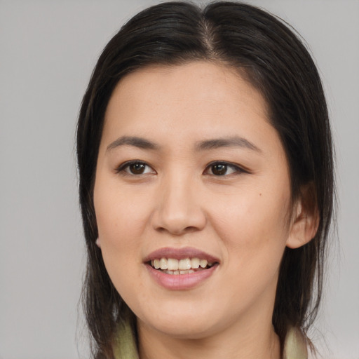 Joyful white young-adult female with long  brown hair and brown eyes