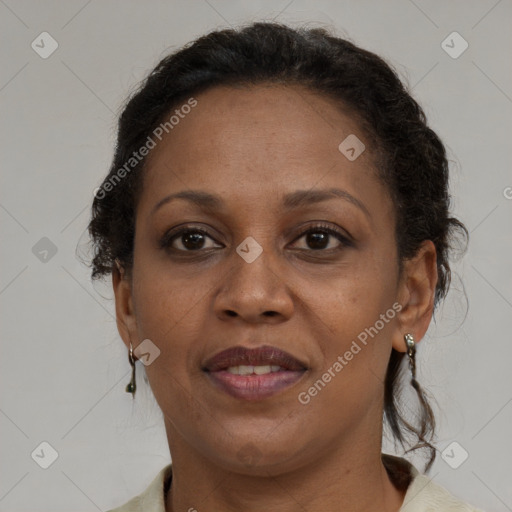 Joyful black adult female with medium  brown hair and brown eyes