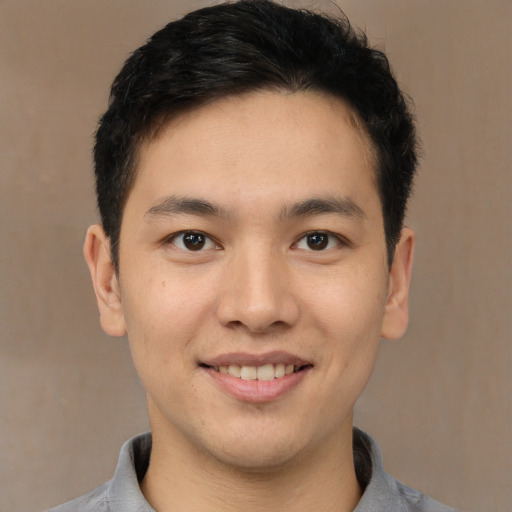 Joyful latino young-adult male with short  brown hair and brown eyes