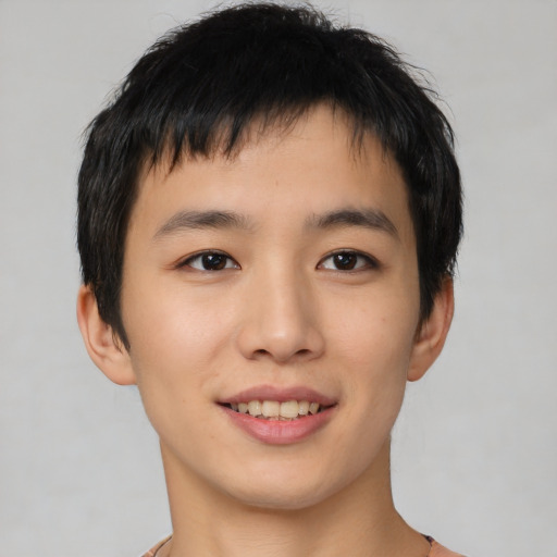 Joyful asian young-adult male with short  black hair and brown eyes