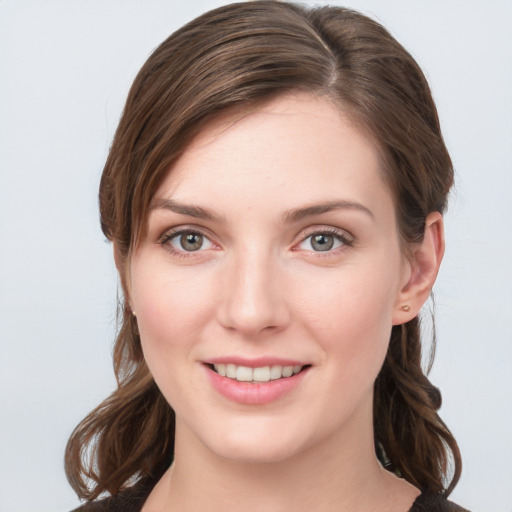 Joyful white young-adult female with medium  brown hair and grey eyes