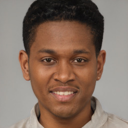 Joyful latino young-adult male with short  brown hair and brown eyes