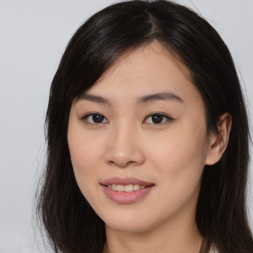 Joyful asian young-adult female with long  brown hair and brown eyes