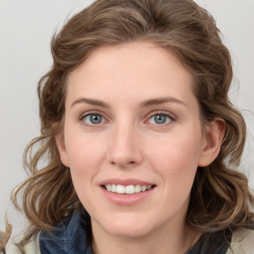 Joyful white young-adult female with medium  brown hair and blue eyes