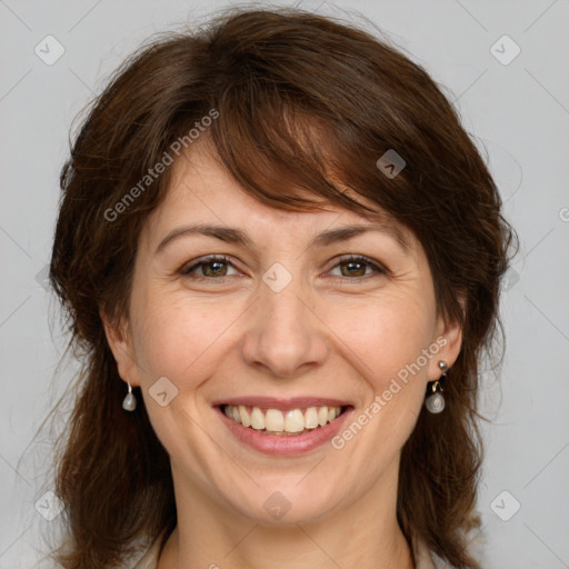 Joyful white adult female with medium  brown hair and grey eyes