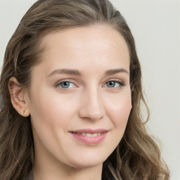 Joyful white young-adult female with long  brown hair and blue eyes