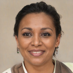 Joyful latino adult female with short  brown hair and brown eyes