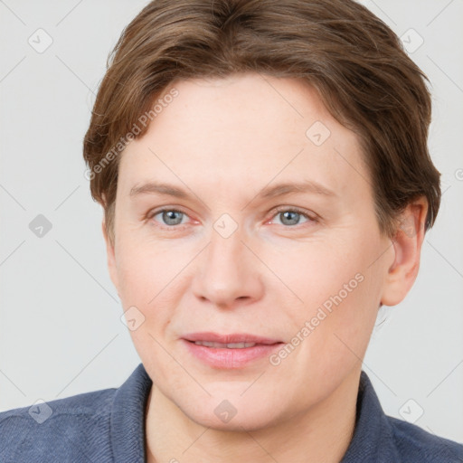 Joyful white young-adult female with short  brown hair and blue eyes