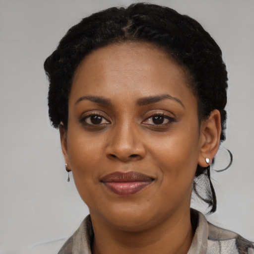 Joyful black adult female with short  black hair and brown eyes