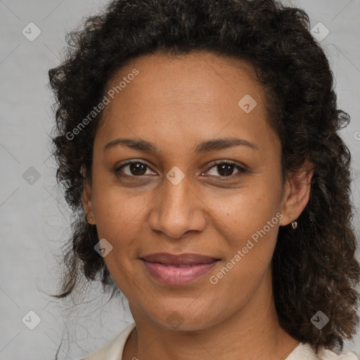 Joyful black adult female with medium  brown hair and brown eyes