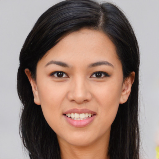 Joyful asian young-adult female with long  brown hair and brown eyes