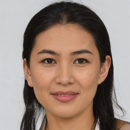 Joyful latino young-adult female with long  brown hair and brown eyes