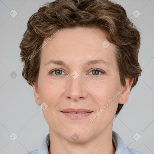 Joyful white adult female with short  brown hair and grey eyes