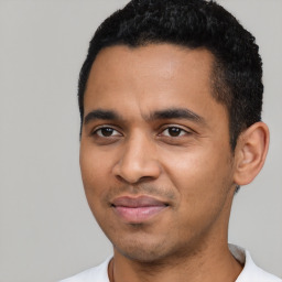 Joyful latino young-adult male with short  black hair and brown eyes