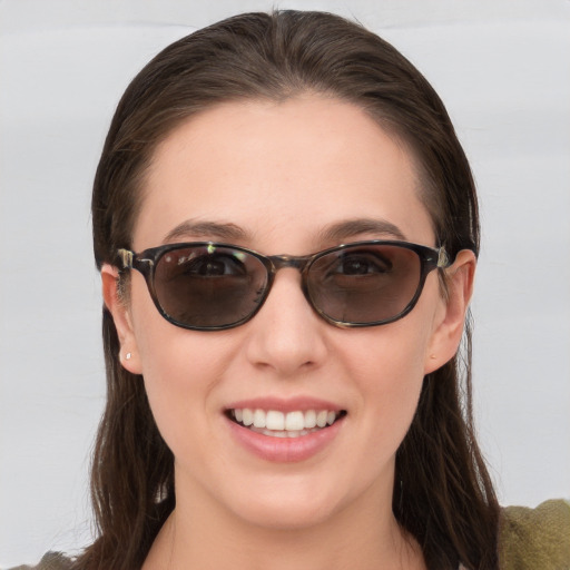 Joyful white young-adult female with medium  brown hair and blue eyes