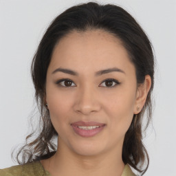 Joyful latino young-adult female with medium  brown hair and brown eyes
