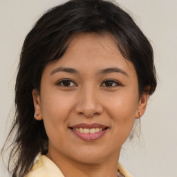 Joyful asian young-adult female with medium  brown hair and brown eyes