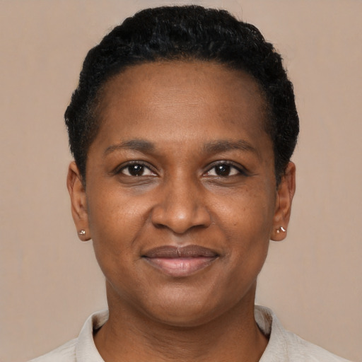 Joyful black young-adult female with short  brown hair and brown eyes