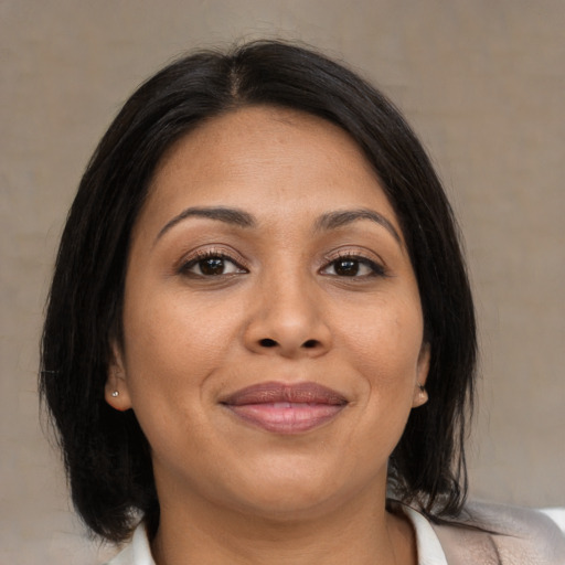 Joyful asian adult female with medium  brown hair and brown eyes