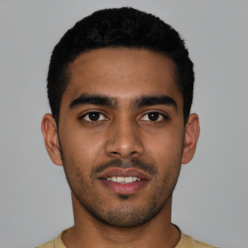 Joyful latino young-adult male with short  black hair and brown eyes