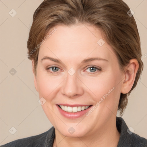 Joyful white adult female with medium  brown hair and grey eyes