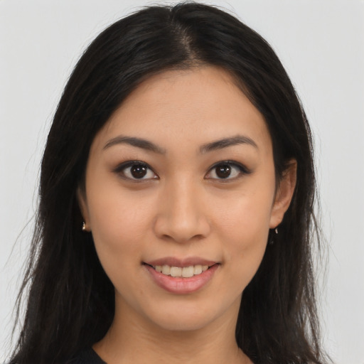Joyful latino young-adult female with long  brown hair and brown eyes