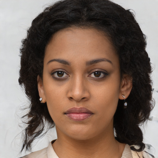 Neutral black young-adult female with long  brown hair and brown eyes