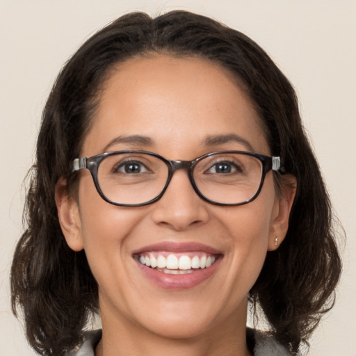 Joyful white adult female with medium  brown hair and brown eyes