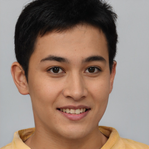 Joyful latino young-adult male with short  brown hair and brown eyes