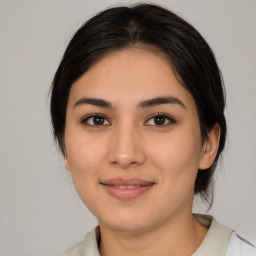 Joyful latino young-adult female with medium  brown hair and brown eyes