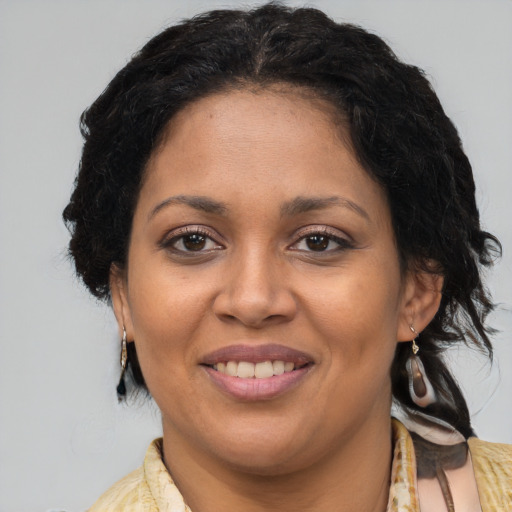 Joyful latino adult female with medium  brown hair and brown eyes