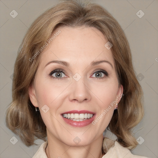 Joyful white adult female with medium  brown hair and blue eyes