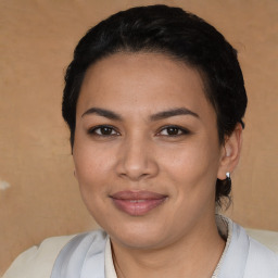 Joyful latino young-adult female with short  black hair and brown eyes