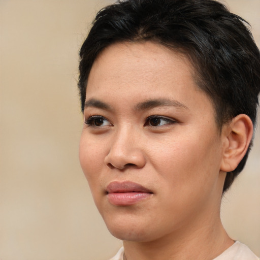Joyful asian young-adult female with short  brown hair and brown eyes