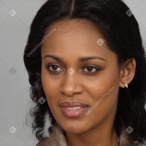 Joyful black young-adult female with long  black hair and brown eyes