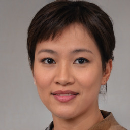 Joyful asian young-adult female with medium  brown hair and brown eyes