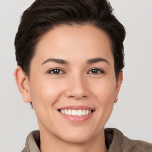 Joyful white young-adult female with short  brown hair and brown eyes