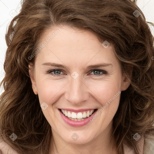 Joyful white young-adult female with long  brown hair and green eyes