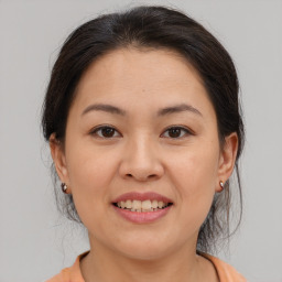 Joyful asian young-adult female with medium  brown hair and brown eyes