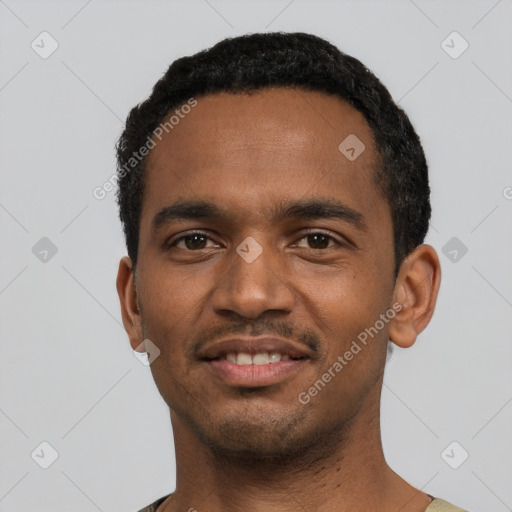 Joyful black young-adult male with short  black hair and brown eyes