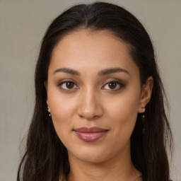 Joyful latino young-adult female with long  brown hair and brown eyes