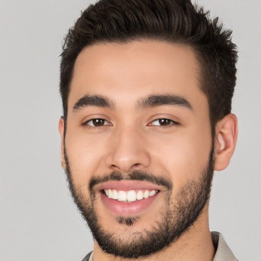 Joyful white young-adult male with short  black hair and brown eyes