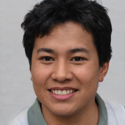 Joyful asian young-adult male with short  brown hair and brown eyes