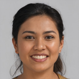 Joyful latino young-adult female with medium  brown hair and brown eyes