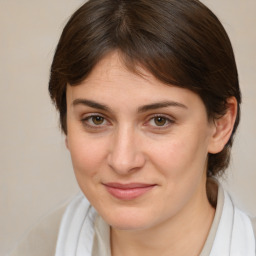 Joyful white young-adult female with medium  brown hair and brown eyes