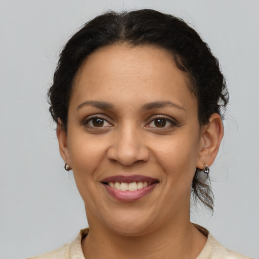 Joyful latino young-adult female with short  brown hair and brown eyes