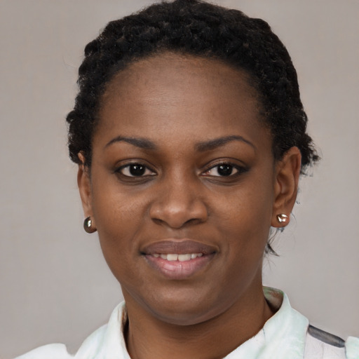 Joyful black young-adult female with short  black hair and brown eyes