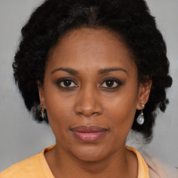 Joyful black adult female with short  brown hair and brown eyes